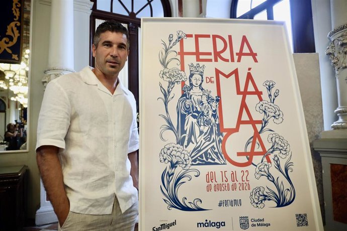 El entrenador del Málaga CF Juan Francisco Funes, posa junto al cartel anunciador de la Feria de Málaga 2026 tras ser nombrado su pregonero. A 3 de agosto de 2026 en Málaga (Andalucía, España).