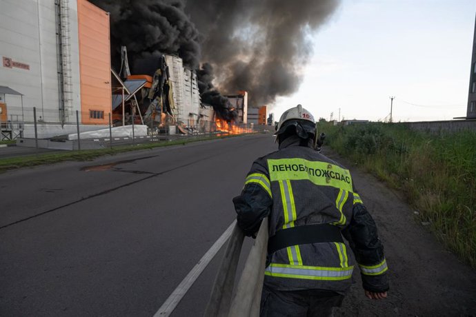 July 24, 2026, St. Petersburg, Russia: A firefighter takes part in extinguishing a fire at the warehouse of the Russian online retailer Wildberries in the Utkina Zavod area, near the village of Novosaratovka, after it caught fire following a drone attack.