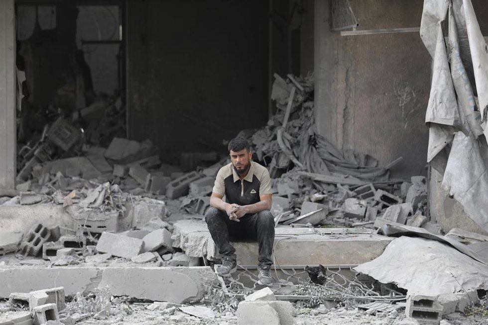Un palestino sobre las ruinas de un edificio en Nuseirat, en la Franja de Gaza