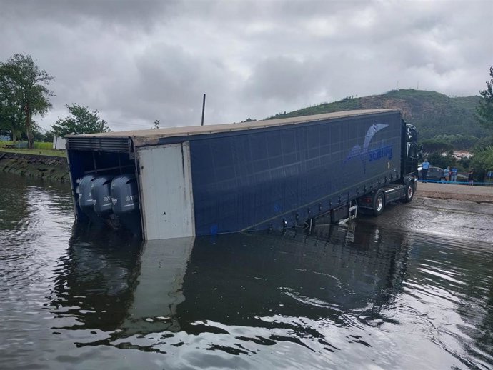 Camión parcialmente afundido nunha zona do río Miño en Caminha (Portugal) cunha embarcación de alta velocidade no seu interior.