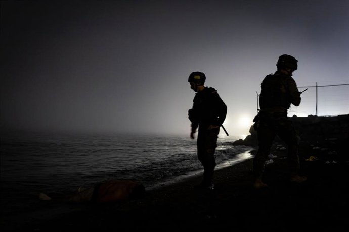 01 August 2026, Spain, Ceuta: Armed police officers stand guard at the Tarajal border crossing in the Spanish enclave of Ceuta. 