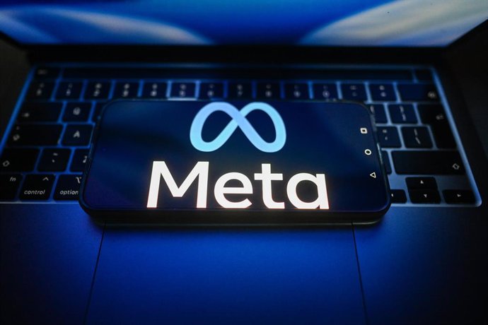 July 15, 2026, Poland: In this photo illustration, the Meta logo is seen displayed on a smartphone on the top of a laptop.