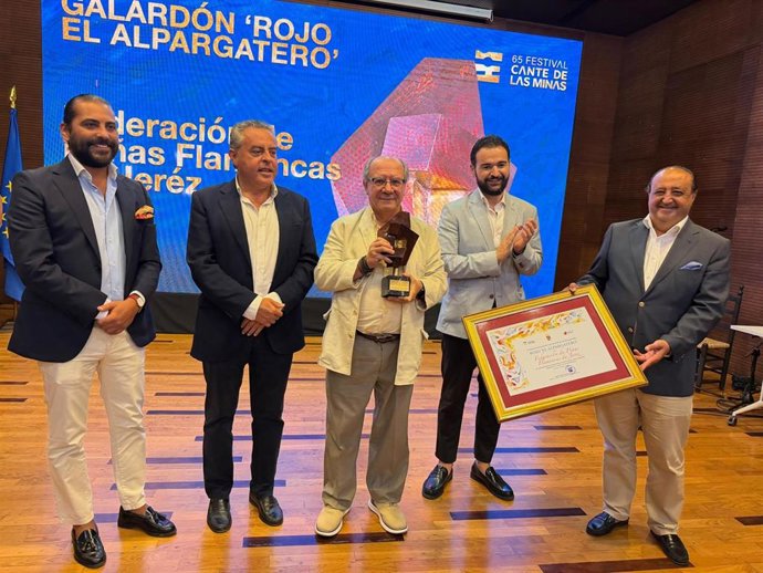 Representantes de la Federación de Peñas Flamencas de Jerez de la Frontera (Cádiz) recogiendo el premio 'Rojo El Alpargatero' en la 65 edición del Festival del Cante de Las Minas.
