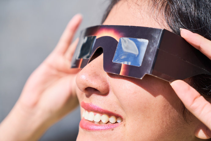 Mujer con gafas solares para eclipse