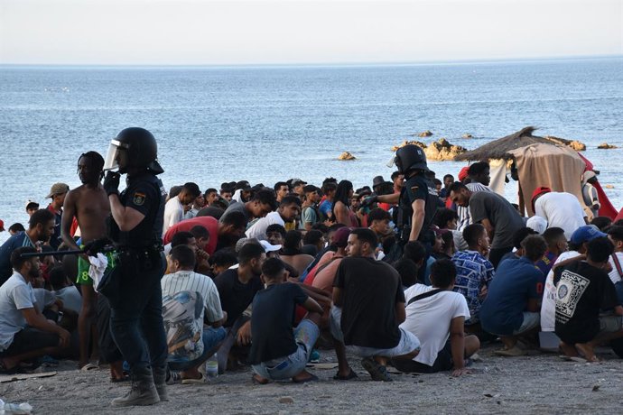 Centenas de migrantes recebem atendimento médico de profissionais do INGESA e voluntários da Cruz Vermelha na praia do Trampolín, em 7 de agosto de 2026, em Ceuta (Espanha). Profissionais do Instituto Nacional de Gestão Sanitária (INGESA) e volu