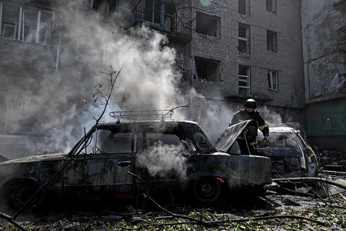 August 10, 2026, Zaporizhzhia, Ukraine: A rescuer extinguishes a fire in a car destroyed by a Russian air strike, Zaporizhzhia, Ukraine, August 10, 2026. Russian forces attacked civilian infrastructure in the regional capital and the Zaporizhzhia district