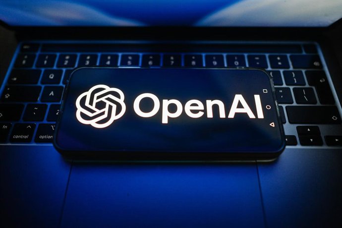 July 15, 2026, Poland: In this photo illustration, an OpenAI logo is seen displayed on a smartphone on the top of a laptop.