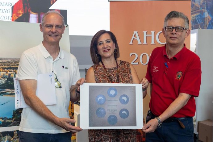 A secretária de Cultura, Educação e Turismo, Sara Fernández, recebe uma reprodução da primeira fotografia de um eclipse solar das mãos de Rémi Cabanac (Observatório Pic du Midi) e de Durruty de Alba (Universidade de Guadalajara).