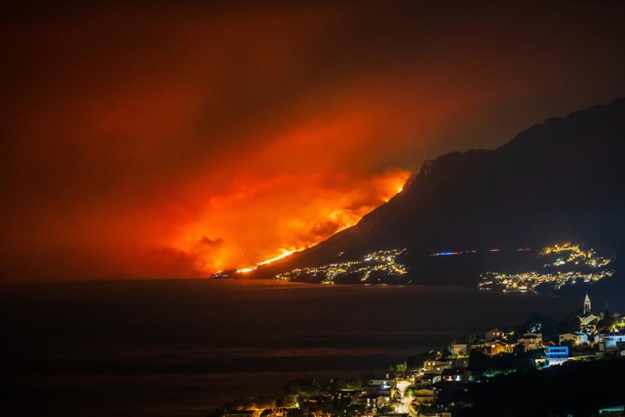 OMIS, Aug. 14, 2026  -- This photo taken on Aug. 13, 2026 shows a massive wildfire near the coastal town of Omis, Croatia.   At least 1,000 residents and tourists have been evacuated after a massive wildfire spread into the coastal town of Omis in souther