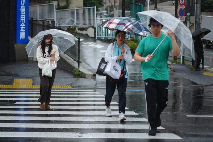 Archivo - Arquivo - TÓQUIO, 3 de junho de 2026  -- Pessoas com guarda-chuvas caminham por uma rua sob a chuva causada pelo tufão Jangmi em Tóquio, Japão, em 3 de junho de 2026.