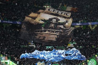 19 August 2026, United Kingdom, Glasgow: A large banner depicting a ship with a skeleton and the words 'Celtic' is pictured in the stands before the UEFA Champions League play-off first leg soccer match between Celtic and LASK at Celtic Park. Photo: Andre