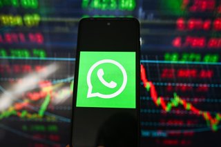 Archivo - March 11, 2026, Poland: In this photo illustration, a WhatsApp logo is displayed on a smartphone with stock market percentages in the background.
