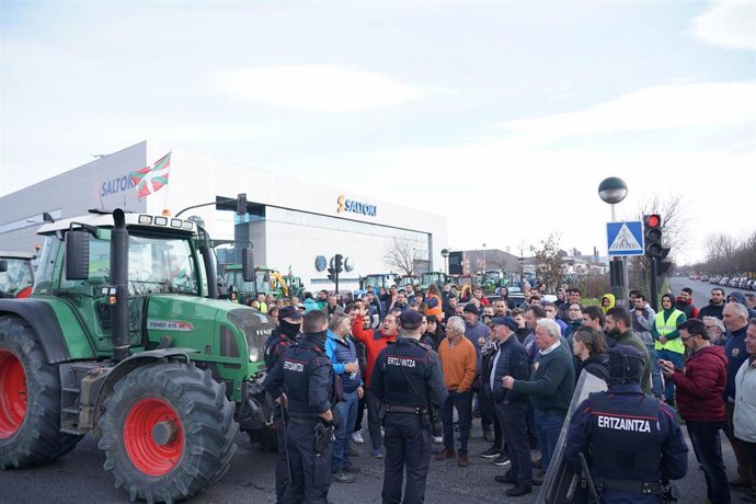 Archivo - Agentes de la Ertzaintza delante de los tractores y agricultores durante una protesta del sector primario