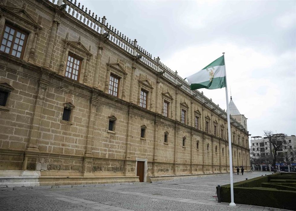Archivo - La bandera de Andalucía ondea ante la fachada del Parlamento. (Foto de archivo).