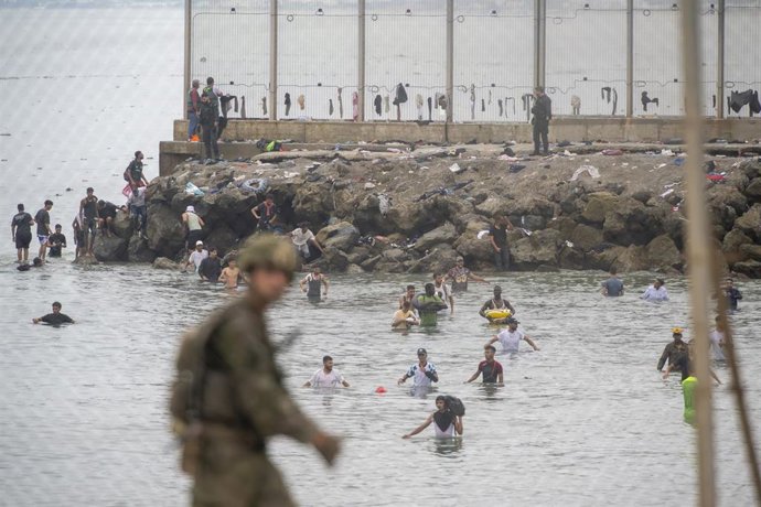 Archivo - Decenas de personas cruzando la frontera española en Ceuta