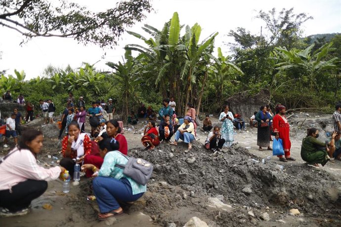 Personas esperan para subir a un twin tradicional para cruzar el crecido río Trishuli, tras las devastadoras inundaciones repentinas que azotaron la zona de Nuwakot, Nepal, el viernes 4 de septiembre de 2026.