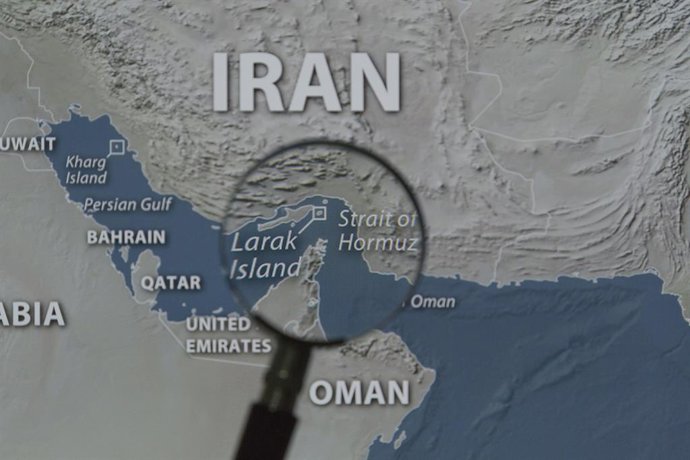 August 31, 2026, Taichung, Taiwan: A magnified image of a map through a handheld magnifying glass depicts the Larak Island and the Strait of Hormuz.