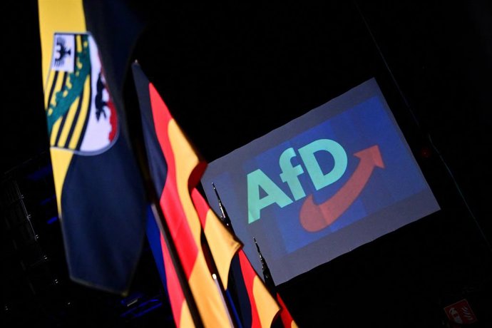 6 de setembro de 2026, Saxônia-Anhalt, Magdeburgo: Bandeiras alemãs e a bandeira do estado da Saxônia-Anhalt (à esquerda) podem ser vistas ao lado do logotipo da AfD do lado de fora do evento eleitoral do partido Alternativa para a Alemanha (AfD) no Altes