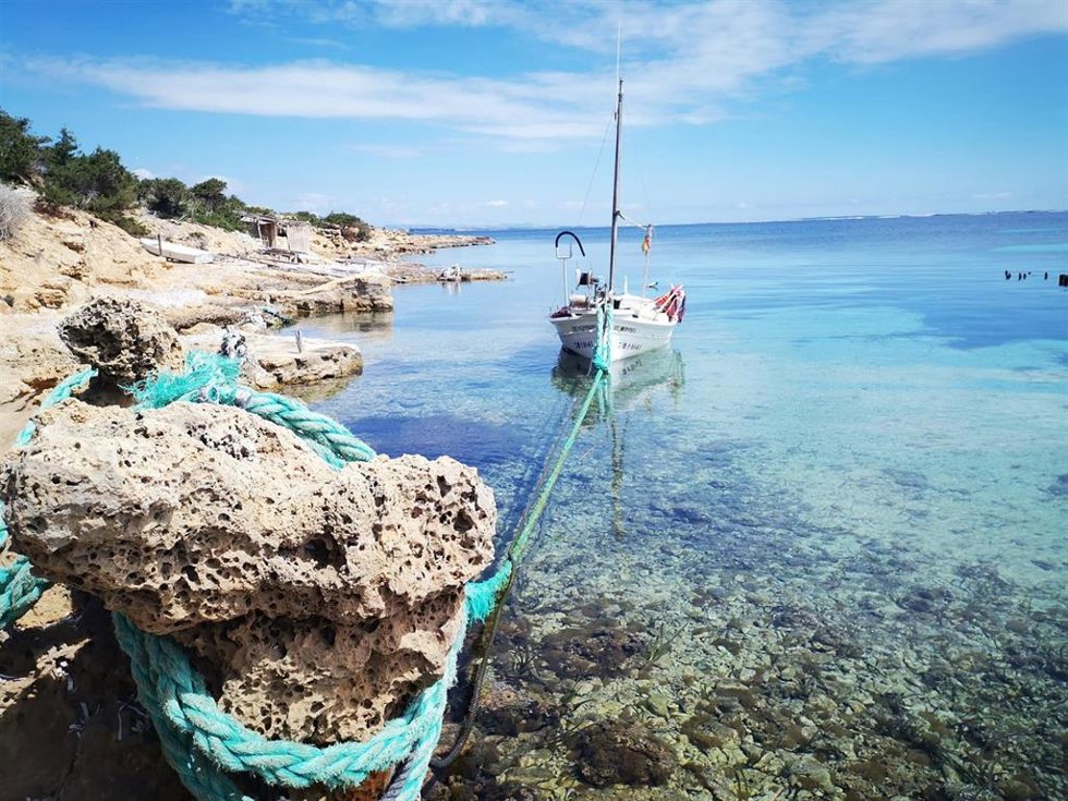 Un barco en una zona marina somera de Baleares.