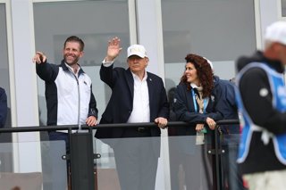 12 September 2026, Ireland, Doonbeg: US President Donald Trump with his son Eric Trump (C) waving to spectators at the Irish Open at the Trump International Golf Links & Hotel in Doonbeg, during his trip to the Republic of Ireland. Photo: Damien Eagers/PA