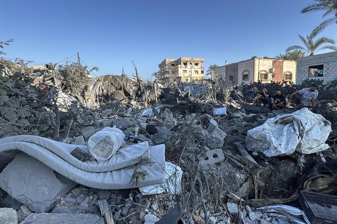 August 25, 2026, Deir Al-Balah, Gaza, Palestinian Territory: Palestinians inspect destruction caused by an Israeli strike that hit residents' homes, displacement tents and a food aid warehouse in Deir el-Balah, in the central Gaza Strip.