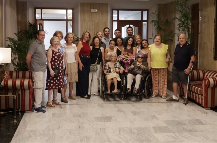 Inés Cuadrado, primera en silla de ruedas por la derecha, acompañada de su familia en la celebración de su 103 cumpleaños en el marco del programa 'Cordobeses Centenarios'.
