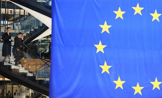 September 16, 2026, Strasbourg, France: Ambassador-designate to the European Union Jonathan Wilkinson, second from left, passes a large EU flag as he walks to take questions from journalists at the European Parliament in Strasbourg, France, on Wednesday, 