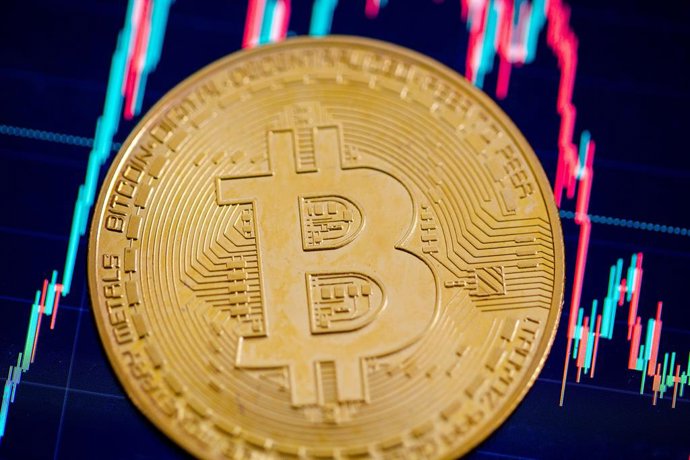 Archivo - Arquivo - ARQUIVADO - 22 de maio de 2023, Berlim: Uma moeda de Bitcoin repousa sobre uma tela que exibe a taxa de câmbio entre o Bitcoin e o dólar americano. Foto: Fernando Gutierrez-Juarez/dpa