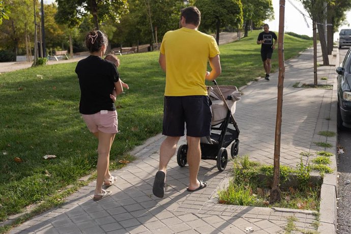 Una pareja con un carrito de bebé.