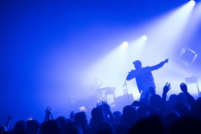 Un hombre cantando durante un concierto en Vitré, Francia