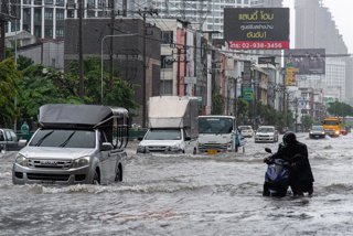 September 26, 2026, Bangkok, Lat Phrao Road, Thailand: A man pushes his motorbike through floodwater along Lat Phrao Road during a flood triggered by heavy rain..Bangkok authorities have declared disaster zones across the city after heavy rain following a