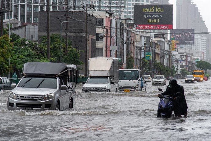September 26, 2026, Bangkok, Lat Phrao Road, Thailand: A man pushes his motorbike through floodwater along Lat Phrao Road during a flood triggered by heavy rain..Bangkok authorities have declared disaster zones across the city after heavy rain following a
