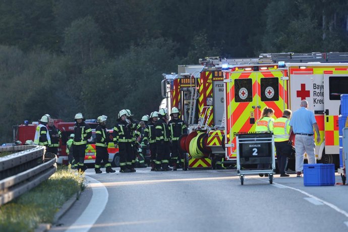 27 September 2026, Bavaria, Buchloe: Emergency services and firefighters are on the scene near Buchloe-Ost, where a tour bus overturned on the A96. Two people were killed and several others were injured, a police spokesperson told the German Press Agency.