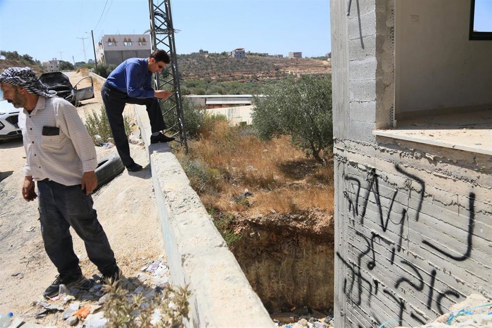 Archivo - Palestinos inspeccionan vehículos quemados después de que colonos israelíes atacaran viviendas, incendiaran tres vehículos y dañaran líneas eléctricas entre las aldeas de Jalud y Tilfit, cerca de Nablus, en la Cisjordania