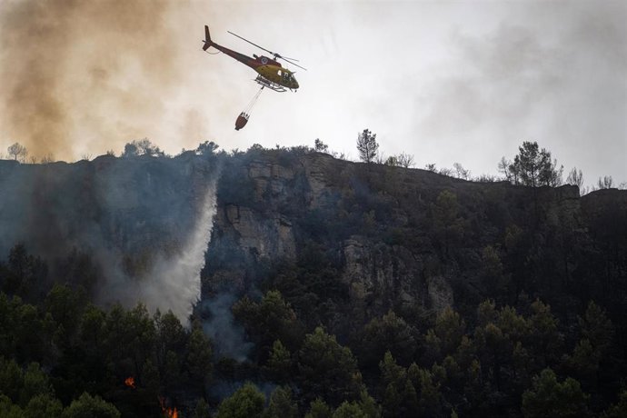 Archivo - Un helicóptero durante las labores de extinción de un incendio, en una imagen de archivo