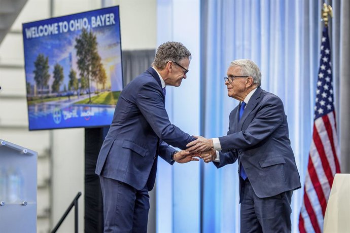 October 2, 2026, New Albany, Ohio, U.S: Bill Anderson, Global CEO, Bayer, left, and Ohio Governor Mike Dewine shake hands on stage Friday, October 2, 2026 at an event where Bayer Pharmaceuticals said it will invest .2 billion in a new pharmaceutical manuf