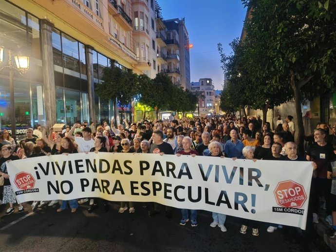Manifestantes por la vivienda en Córdoba con una pancarta de Stop Desahucios Córdoba.