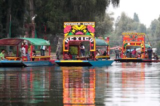 Archivo - 21 August 2020, Mexico, Mexico City: Visitors ride on Trajineras, the colorful boats of Xochimilco. 