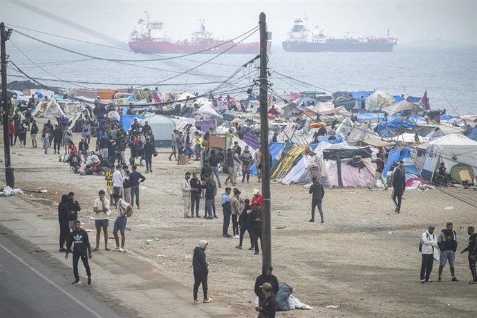 Agentes de la Policía Nacional intervienen durante el proceso de desalojo del embolsamiento de migrantes en la playa de El Trampolín, a 5 de octubre de 2026, en Ceuta (España).