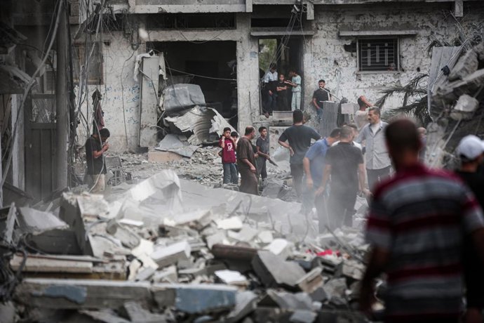October 9, 2026, Gaza City, Gaza Strip, Palestinian Territory: Palestinians inspect their belongings amid the rubble of damaged residential buildings after an Israeli airstrike targeted a house in the Sabra neighborhood, south of Gaza City, on October 9, 
