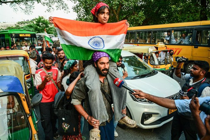 October 16, 2026, New Delhi, India: A protester carries a girl on his shoulders as she holds the Tricolour during a protest demanding the resignation of India's Chief Election Commissioner Gyanesh Kumar over alleged voter roll irregularities linked to the