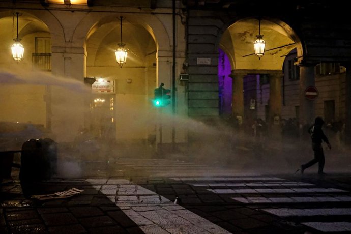 October 17, 2026, Turin, Italy: TURIN, ITALY - OCTOBER 17, 2026: Police clashed with students after a pacific demonstration against the high cost of life and gasoline. As police was using teargas and water pumps to disperse the crowd, a woman tried to pro