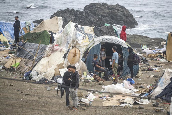 Agentes de la Policía Nacional intervienen durante el proceso de desalojo del embolsamiento de migrantes en la playa de El Trampolín, a 5 de octubre de 2026, en Ceuta (España). La Policía Nacional escolta los autobuses llenos de personas migrantes desaloj