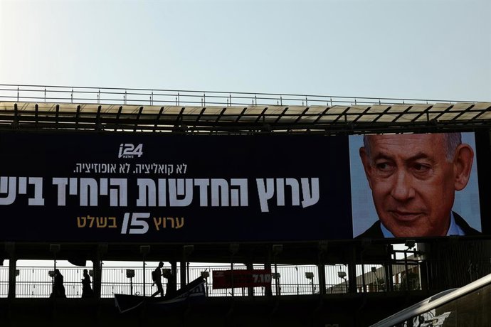 21 de outubro de 2026, Israel, Tel Aviv: Um cartaz de campanha eleitoral com o primeiro-ministro de Israel, Benjamin Netanyahu, líder do partido Likud, está pendurado em uma ponte para pedestres. Os cidadãos devem ir às urnas em 27 de outubro de 2026 para