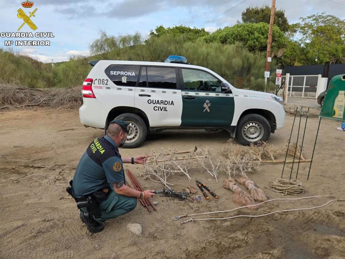 Un agente del Seprona de Median Sidonia con más de 12 metros de longitud de redes abatibles y herramientas y elementos indispensables para la captura ilegal de aves fringílidas en el Parque Natural de la Breña y Marismas de Barbate.