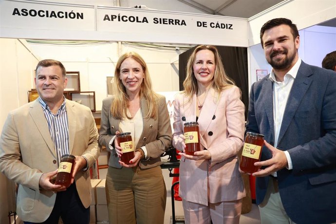 La presidenta de la Diputación de Cádiz, Almudena Martínez (2i), acompañada por la alcaldesa de Prado del Rey (Cádiz), Vanesa Beltrán (2d), asiste a la apertura de la X Feria de la Apicultura de la localidad gaditana. 