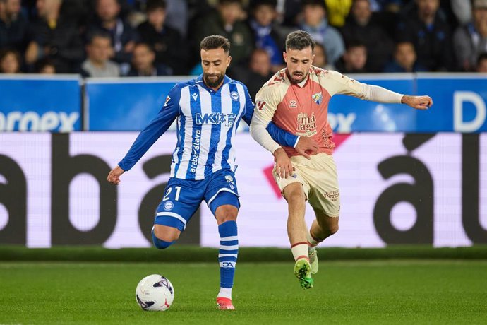 Abde Rebbach of Deportivo Alaves competes for the ball with Carlos Puga of Malaga CF during the LaLiga EA Sports match between Deportivo Alaves and Malaga CF at Mendizorrotza on October 23, 2026, in Vitoria, Spain.