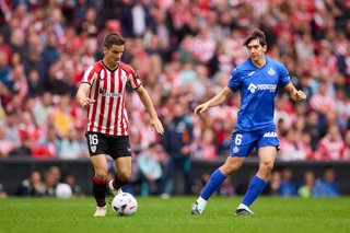 Inigo Ruiz de Galarreta of Athletic Club competes for the ball with Francho Serrano of Getafe CF during the LaLiga EA Sports match between Athletic Club and Getafe CF at San Mames on October 25, 2026, in Bilbao, Spain.