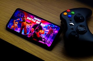 October 18, 2026, Canada: In this photo illustration, the Fortnite Battle Royale game logo is seen displayed on a smartphone screen next to an Xbox video game controller.