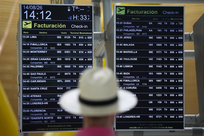 Archivo - Una persona consulta un panel informativo sobre vuelos en el Aeropuerto Adolfo Suárez Madrid-Barajas en Madrid (España). 